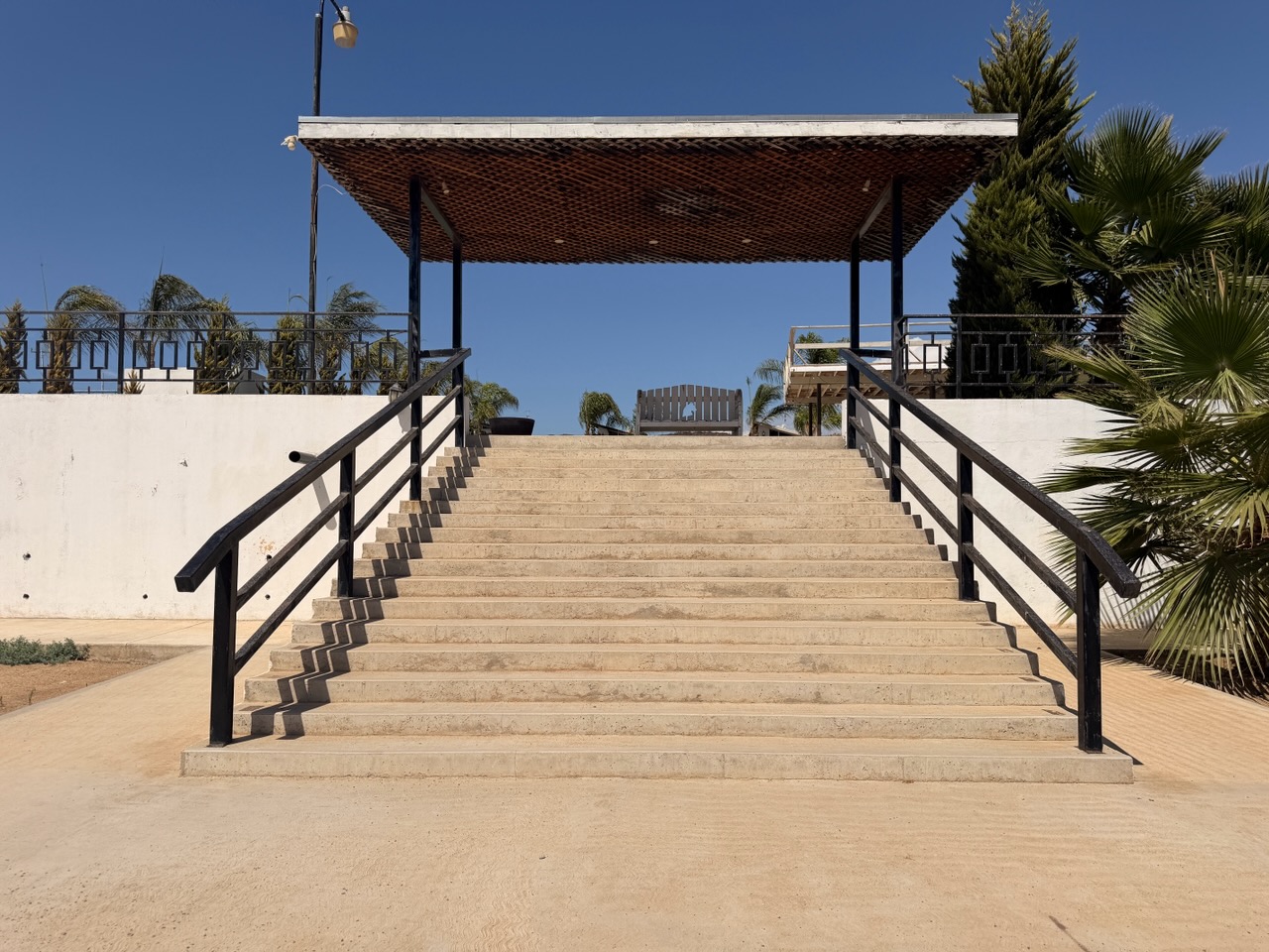 Stairs leading to a covered deck at Iboga Treatment Center in Ensenada, Mexico